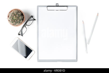 Modern white office desk table with blank paper, smartphone and glasses with small cactus. Blank notebook page for input the text in the middle. Top v Stock Photo