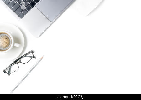 Desk with laptop, eye glasses, pencil and a cup of coffee isolated on white background. Top view with copy space. Stock Photo