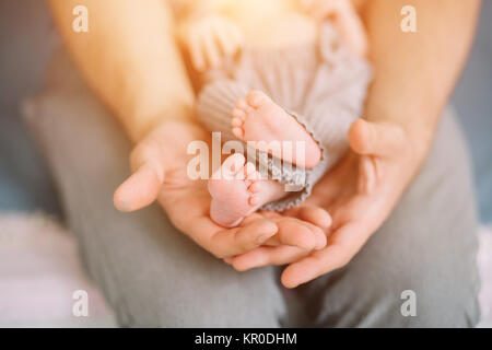 father holding newborn baby little feet Stock Photo