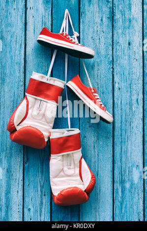 Boxing gloves and shoes hanging on the wall Stock Photo