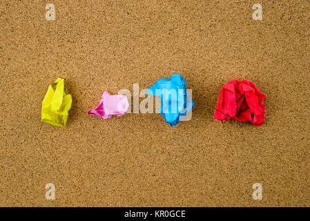 Colorful crumpled papers over cork background Stock Photo