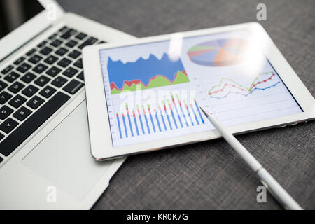 Digital tablet showing charts and diagram Stock Photo