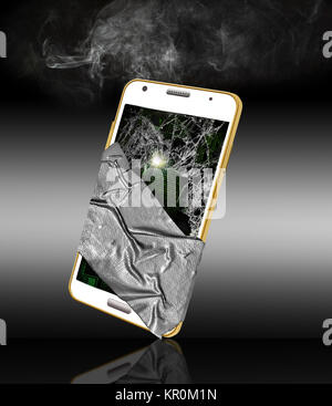 A broken cell phone is cracked, smoking and covered in duct tape in an ...