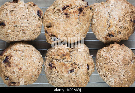 Homemade spelt and cranberry bread rolls on a cooling rack. Stock Photo