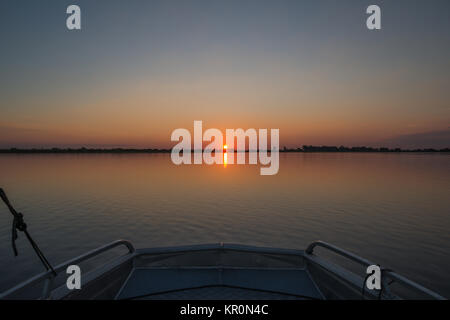 Sunset on river from bow of boat Stock Photo