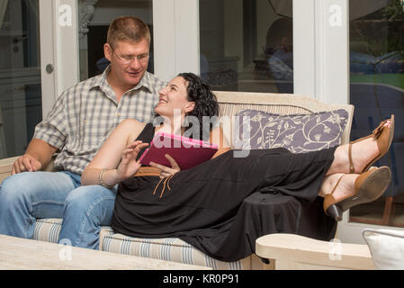Couple on patio with tablet Stock Photo