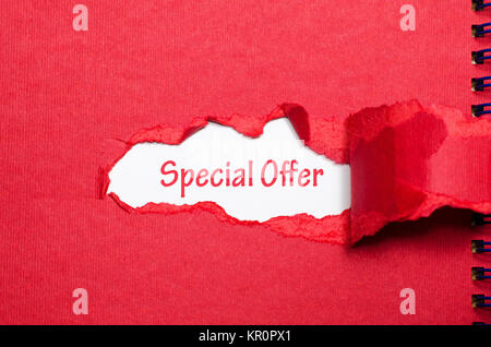 The word special offer appearing behind torn paper Stock Photo