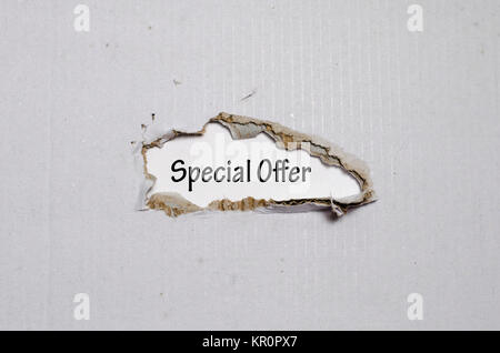 The word special offer appearing behind torn paper Stock Photo