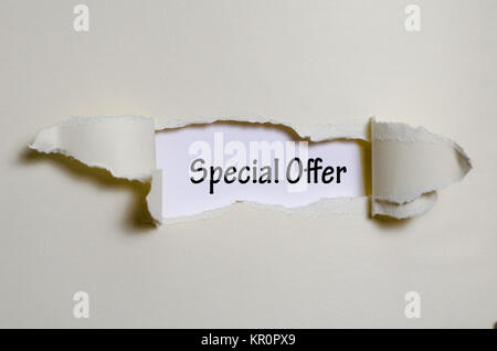 The word special offer appearing behind torn paper Stock Photo
