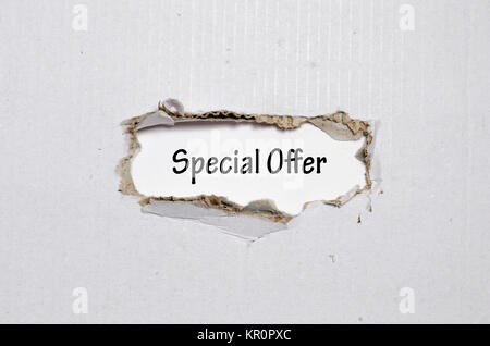 The word special offer appearing behind torn paper Stock Photo