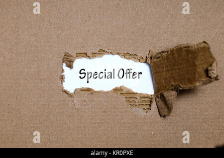 The word special offer appearing behind torn paper Stock Photo