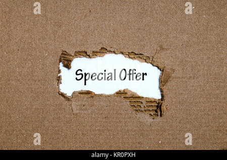 The word special offer appearing behind torn paper Stock Photo