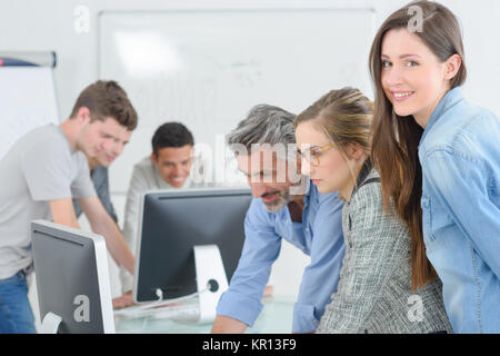 Classroom of students, girl smiling to camera Stock Photo