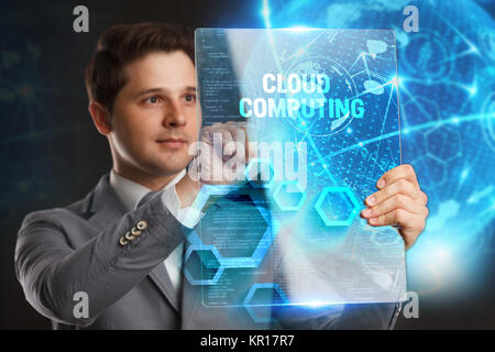 Business, Technology, Internet and network concept. Young businessman showing a word in a virtual tablet of the future:Cloud computing Stock Photo