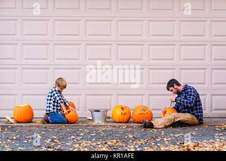 Father And Son Carving Halloween Pumpkins United States