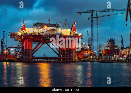 Oil Rig in the shipyard for maintenance at night. Stock Photo