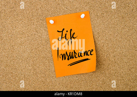 Life Insurance written on orange paper note Stock Photo