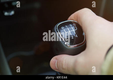 Close up of manual gear stick in hand. Changing gear theme Stock Photo