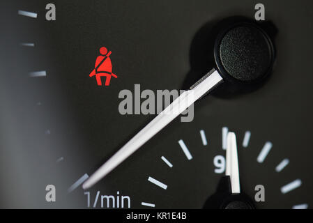 Seat belt icon on car dashboard macro close up Stock Photo