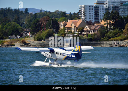 A commuter aircraft speeding up for take off in the harbour at Victoria on Vancouver Island British Columbia Canada. Stock Photo