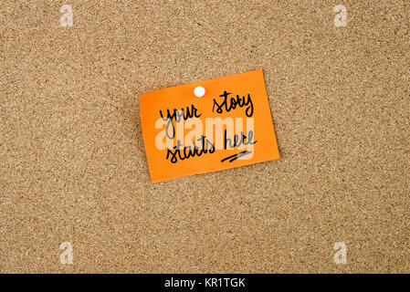 Your Story Starts Here written on orange paper note Stock Photo