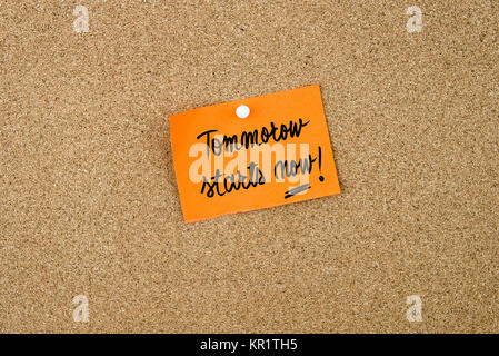 Tomorrow Starts Now written on orange paper note Stock Photo