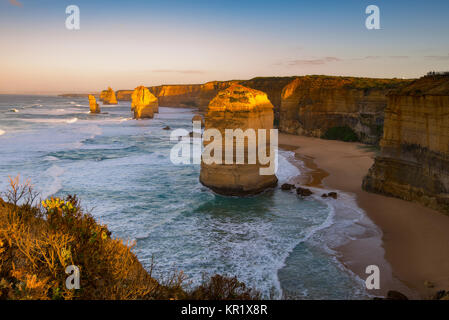 Sunrise over Twelves Apostles in Great Ocean Road, Victoria, Australia. The Twelve Apostles is a collection of limestone stacks off the shore of the P Stock Photo