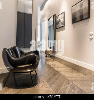Interior with modern black armchair and painting on the wall Stock Photo