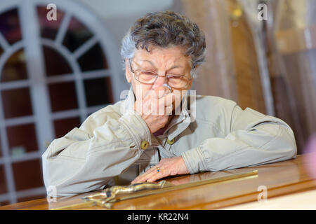 elderly woman with crucifix Stock Photo