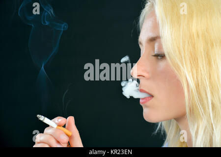 Blond woman smoking Stock Photo