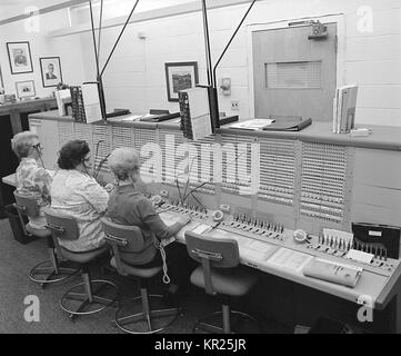 This historic image depicts a number of operators answering calls at what was the Centers for Disease Control and Prevention's (CDC) switchboard. Image courtesy CDC, 1975. Stock Photo