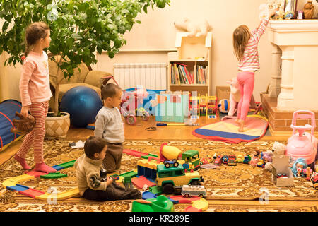 Four children are playing in the children's room Stock Photo