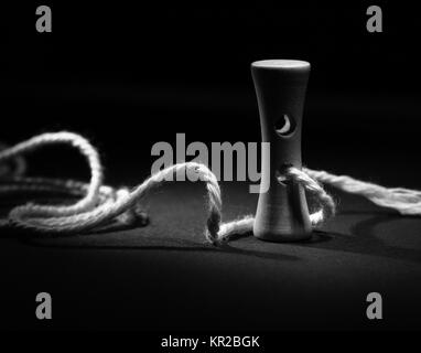 Wooden button with rope in light painting black and white Stock Photo