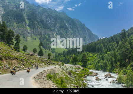 Tourists riding motorbikes in Himalayan mountains on Srinagar - Kargil road in Jammu and Kashmir state, India. Stock Photo