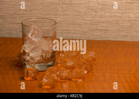 Empty Glass with Ice Cubes and More Around it Stock Photo