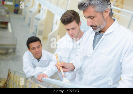 Apprentices learning how to paint Stock Photo