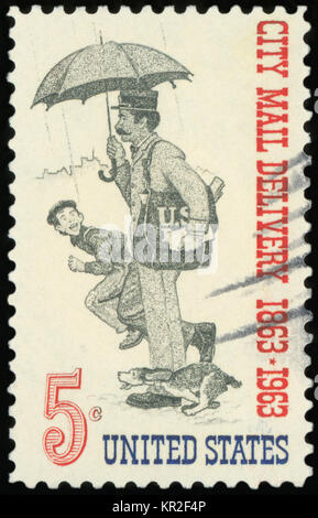 UNITED STATES OF AMERICA - CIRCA 1963: A stamp printed in USA dedicated to the Free City Mail Delivery Centenary shows Letter Carrier, circa 1963 Stock Photo