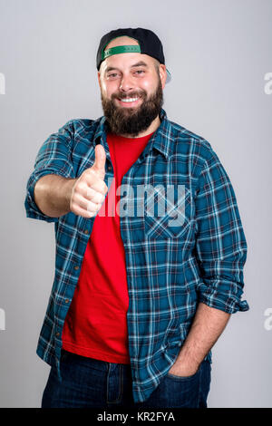 young bearded man with baseball cap with thumb up Stock Photo