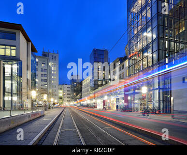 Ernst-Abbe-Platz with traces of light from the tram at dusk, high-rise buildings, glass facades, Jena, Thuringia, Germany Stock Photo