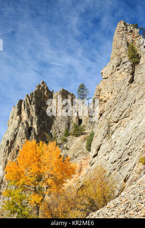 fall colors and cliffs in the bearmouth area along the clark fork river west of drummond, montana Stock Photo