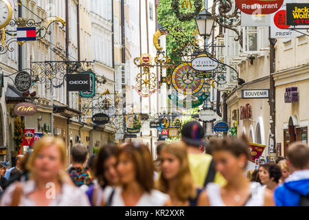 Unidentified People Walking at Famous Historical Shopping Street Getreidegasse in Salzburg. Stock Photo