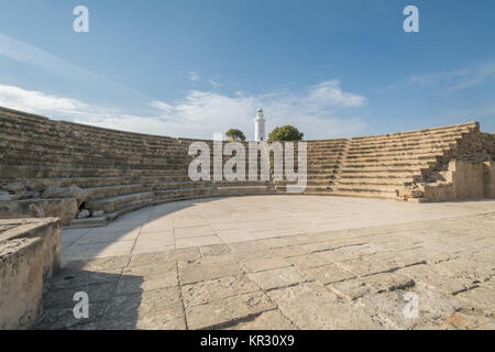 Paphos archaeological park at Kato Pafos in Cyprus, a UNESCO World Heritage Site. View of the Amphitheatre (Odeon) and lighthouse. Stock Photo