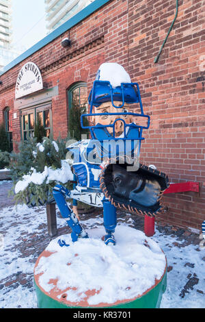 A 'junk art'  sculpture of a baseball catcher by Patrick Amiot on display in the Distillery district of Toronto Canada Stock Photo