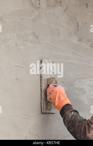 Builder worker plastering concrete Stock Photo