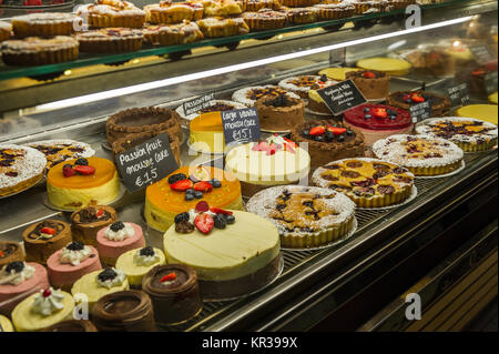 Cakes for sale in a display cabinet in the English Market, Cork, Ireland. Stock Photo