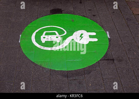 characters for a charging station for electric cars on asphalt Stock Photo