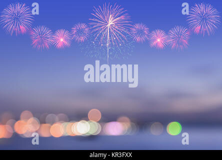 Blurred view of city bokeh with fireworks on sky Stock Photo