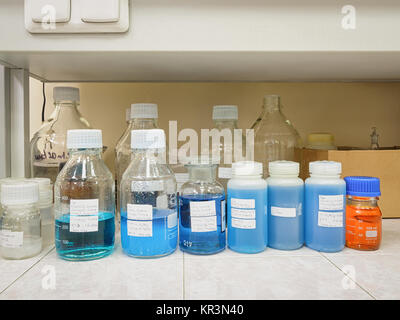 Blue solution in chemical containers in a chemical laboratory Stock Photo