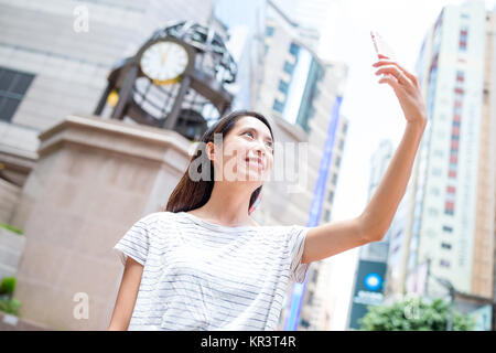 Woman taking selfie in causeway bay of Hong Kong city Stock Photo