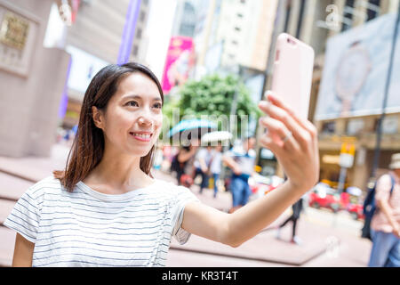 Woman taking selfie in causeway bay of Hong Kong city Stock Photo - Alamy